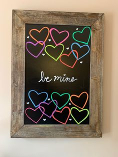 a chalkboard with hearts drawn on it and the words le mine written in french