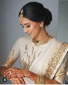 a woman with henna and jewelry on her hands