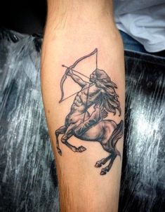 a man with a tattoo on his arm holding a bow and arrow in the shape of a horse