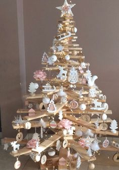 a wooden christmas tree with ornaments on it