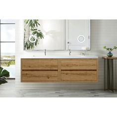 a bathroom vanity with two sinks and mirrors