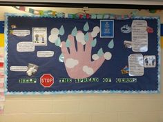 a bulletin board with handprints on it in a school hallway, surrounded by papers and magnets