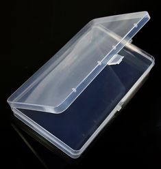 two clear plastic containers sitting on top of a black table