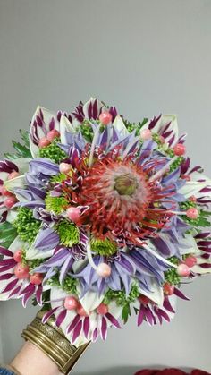 a person holding a bouquet of flowers in their hand