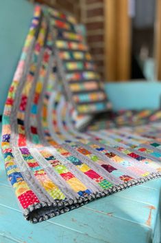 a quilted table runner sitting on top of a blue chair