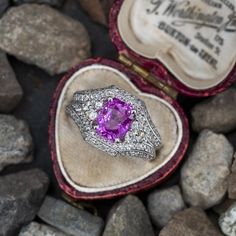 This gorgeous ring is centered with one (1) cushion cut natural pink sapphire set into a four-prong head. The top half of the ring is accented with ninety- six (96), bead/prong set, round brilliant cut diamonds. The diamonds are bordered with milgrain edging. The ring measures 12.8mm at the top, rises 7.1mm above the finger, tapering to 4.0mm wide and 1.5mm thick at the base of the shank. This ring is currently a size 5.75. Pink Sapphire Engagement Ring, Pink Sapphire Ring Engagement, Gorgeous Ring, Sapphire Engagement Ring, Sapphire Engagement, Engagement Rings Sapphire, Brilliant Diamond, Round Brilliant Cut Diamond, Cushion Cut