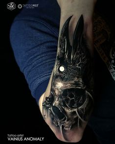 a person with a tattoo on their arm and the image of a demon is shown