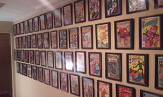 a wall full of comic books and framed pictures