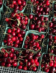 many cherries are in baskets on the table