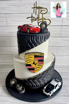 a three tiered cake with cars on top and the words happy birthday to porsche