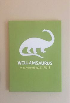 a green book with an image of a dinosaur on it