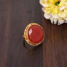 Natural Red Sardonyx Gemstone Ring, Gold Plated Ring, Brass Ring, August Birthstone Ring, Round Shape Ring, Gemstone Ring, Engagement Gift Description : Metal : Brass Gemstone : Natural Red Sardonyx Stone Size  :19x19 MM Approx Weight : 5.54 Gram Approx ❣❣ Handmade Item ❣❣   **Made to Order** » G EM S T O N E D E T A I L « **Gemstone structure may vary from the image as two gemstones do not have the same structure** If you want to see the picture of gemstone, then feel free to contact us. » C U S T O M I Z E O R D E R « All gemstone jewelry is made with silver and brass. If you want to make any changes with this jewelry, then please send us a message. We will make as per your requirements. For more beautiful designs please visit our Etsy shop below: https://www.etsy.com/shop/MissomaSantiag Red Oval Rings With Natural Stones, Adjustable Red Gemstone Rings, Ruby Crystal Ring With Stone Setting, Red Stone Rings For Anniversary, Red Cabochon Round Stone Jewelry, Adjustable Red Gemstone Birthstone Ring, Red Rings With Stones As A Gift, Red Rings With Stones For Gift, Red Carnelian Wedding Jewelry