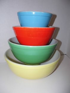 three different colored bowls stacked on top of each other