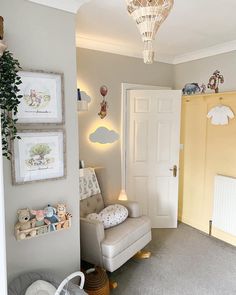 a baby's room with a rocking chair and other items on the wall in front of it