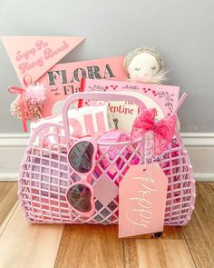 a pink basket filled with lots of items