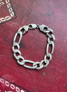 "* Vintage Italian handmade sterling silver cuban curb link chain bracelet.  * Stamped \"Italy\", and \".925\".  * Bracelet measures at 9.5 inches long. Each small link measures at .85 inch long x .55 inch wide.  * Weight- 64.4 grams Please view and inspect the photos closely, as they are considered part of the condition. I endeavor to fully disclose all condition information clearly, however, please note that what qualifies as excellent condition for historical jewelry differs from modern and contemporary pieces. Minor age wear is typical and to be expected for antique and vintage jewelry. All items are unpolished and in their vintage condition, items can easily be polished up if so desired. Enjoy,  Dev" Classic Silver Cuban Link Bracelet, Classic Silver Cuban Link Bracelet With Oval Links, Classic Sterling Silver Cuban Link Bracelet, Classic Cuban Link Silver Chain Bracelet, Classic Sterling Silver Cuban Link Bracelet With Silver Chain, Classic Silver Cuban Link Bracelet For Everyday, Sterling Silver Curb Chain Bracelet With Oval Links, Silver Cuban Link Bracelet With Oval Links, Silver Oval Link Curb Chain Bracelet