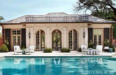 an outdoor swimming pool with chairs around it and a gazebo in the back ground