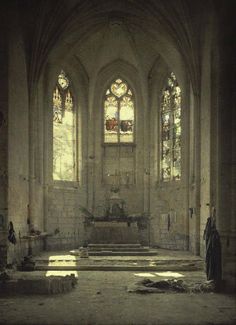 the interior of an old church with stained glass windows