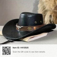 a black cowboy hat sitting on top of a table next to a stuffed teddy bear