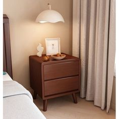 a night stand with two bowls on it next to a bed and curtains in the background