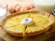 a pie sitting on top of a wooden cutting board