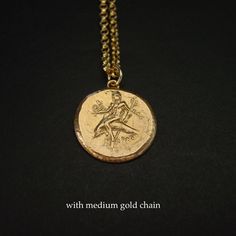 "Greek coin necklace of Taras, the boy riding dolphin. Taras was the son of Poseidon, god of the sea. Most coins of the city bearing his name show the patron deity riding on the back of a dolphin and holding a sea horse. Inscription: TAΡAΣ Greek coin reproduction from 315 - 302 BC Calabria, Tarentum (present day Italy). - Handmade coin reproduction - Solid yellow bronze also called jeweler gold bronze. - One sided coin - Soldered bronze eyelet on top. - Signed in the back by artist - Coin is abo Mythological Medallion Jewelry In Gold, Mythological Style Gold Coin Pendant Jewelry, Gold Mythological Coin Pendant Jewelry, Gold Mythological Jewelry With Coin Pendant, Mythological Medallion Jewelry Gift, Mythological Engraved Round Pendant Jewelry, Mythological Round Pendant Necklace For Gifts, Mythological Style Yellow Gold Jewelry As Gift, Mythological Style Yellow Gold Jewelry Gift