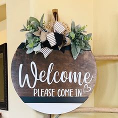 a welcome sign hanging from the side of a wall