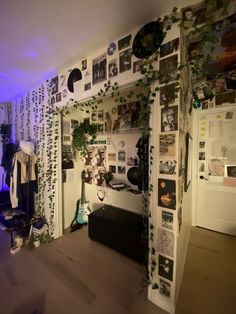 a room with many pictures on the wall and plants growing out of the closet doors