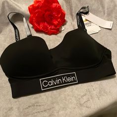 Calvin Klein Women's Ck One Cotton Lightly Lined Bralette With 3 Row Hook & Eye. Size - M, Color Black *** New Wt *** Spring Padded Bras, Fitted Padded Sports Bra, Trendy Stretch Black Bra, Black Padded Bra, Trendy Black Stretch Bra, Black Seamless Sports Bra For Spring, Trendy Black Sports Bra For Spring, Black Sports Bra With Built-in Bra For Spring, Black Padded Cup Bra