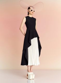 The Severny is a modern cocktail style featuring a draped asymmetric peplum and contrasting sunray pleated skirt. Black And White Classy Dress, Modern Cocktail, Pleat Dress, Solace London, Black Peplum, Dress Black And White, Midi Length Dress, Casual Party, White Skirts