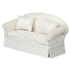 a white couch with two pillows on it and one pillow is folded over the back