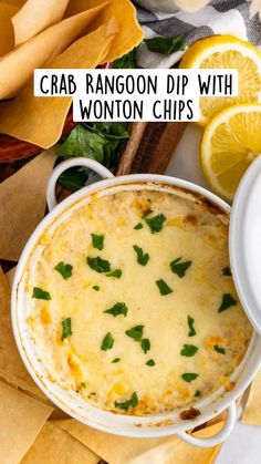 a casserole dish with cheese and garnished with parsley next to chips