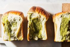 three pieces of bread with pesto on them