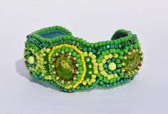 New-to-me Artist - Beautiful beaded work -- Green yellow beaded embroidered cuff bracelet by ExclusiveCraft, $126.00 Green Handmade Cuff Bracelet, Handmade Green Cuff Bracelets, Handmade Wearable Art Green Bracelets, Handmade Green Cuff Jewelry, Handmade Green Wearable Art Bracelet, Handmade Green Beaded Bracelet, Handmade Green Cuff Bracelet, Bohemian Green Cuff Bracelet, Embroidery Bracelet