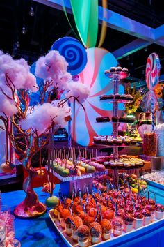 an assortment of desserts and candies displayed on a table