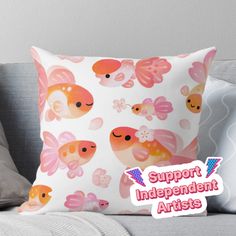 a pillow with an image of fish on it and the words support independent artists above it