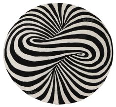 a black and white circular rug with an abstract swirl design on the center, in front of a white background