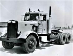 a black and white photo of a large truck