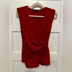 This Beautiful Zara Blouse In Size Medium And Vibrant Red Color Is Perfect For Any Occasion, From Formal Events To Casual Outings. It Features A Sleeveless Design With A Flattering V-Neckline And A Hidden Inseam Side Zip Closure. The Blouse Also Has A Few Unique Accents Such As Ruching On The Sides And Shoulder Pads For A More Structured Look. It Is Made Of Lightweight And Breathable Polyester Material, Making It Ideal For Summer And Spring Seasons. This Blouse Is A Classic Piece That Belongs In Red Sleeveless Tank Top For Night Out, Zara Sleeveless Top For Date Night, Zara Tank Top For Parties, Elegant Red Tank Top For Night Out, Red Sleeveless Blouse For Work, Red Sleeveless Blouse For Party, Zara Sleeveless Tank Top For Party, Red Zara Tops For Work, Red Tank Top For Evening