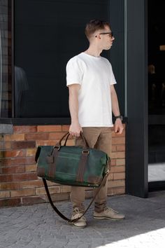 This leather weekender bag is designed to be carried by hand, although it also comes with a shoulder strap. Such a handbag is a good choice for travel or for carrying a lot of belongings - for example, to the gym. Inside the bag there is a zippered pocket for your passport, tickets and other small items.  Metal legs are installed at the bottom of the leather duffel bag - it protects the bottom of the bag from damage. 📐Standart Length - 19 inch (48 cm) Height - 11 inch (27 cm) Width - 11 inch (27 cm) 📐Mini Length - 17.5 inch (45 cm) Height - 10 inch (25 cm) Width - 9 inch (23 cm) ⭐Additionally you can order: ▪️laser engraving of a name or image; ▪️product size adjustment; ▪️worldwide delivery; ▪️gift wrapping (by prior order) 🎨Available colors: ▪️red; ▪️caramel; ▪️green; ▪️olive; ▪️scotc Green Leather Duffle Bag With Luggage Sleeve, Green Leather Travel Bag With Luggage Sleeve, Green Duffle Bag With Luggage Sleeve, Green Leather Weekender Bag For Travel, Green Leather Travel Weekender Bag, Green Leather Weekender Bag, Green Leather Travel Bag For Daily Use, Green Leather Duffle Bag For Everyday Use, Everyday Use Green Leather Duffle Bag