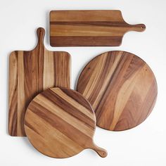 three wooden cutting boards and one serving board