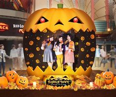 two girls are standing in front of a pumpkin with their faces carved into the shape of a jack - o - lantern