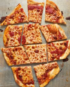 sliced pizza sitting on top of a pan covered in cheese and pepperoni toppings