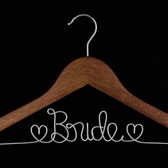 a wooden hanger with the word bride written on it