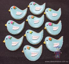 decorated cookies in the shape of birds on a table