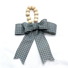 a wooden beaded necklace with a bow on it