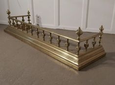 a gold metal bed frame sitting on the floor