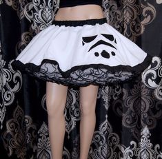 "The main fabric is soft White Bridal Tulle. The waistband is Black cotton over elastic. Then I finished it off with more black piping on the hem. It's the perfect companion crinoline for my Storm Trooper Circle skirt shown in last picture (not included with this listing) This skirt is stitched and serged to last a lifetime. It's safe for the washing machine and the dryer. Measurements: Waist Size Small: 24\" to 32\" Medium: 33\" to 42\" Large: 42\" to 50\" Length: 14\" NOTE This listing is only Cosplay Petticoat With Attached Cancan, White Fitted Petticoat For Costume Party, Fitted White Petticoat For Costume Party, Fitted Princess Petticoat For Costume Party, White Cancan Petticoat For Costume Party, White Costume Skirt With Attached Cancan, White Skirt For Halloween Costume Party, White Skirt With Attached Cancan For Costume Party, White Petticoat For Costume