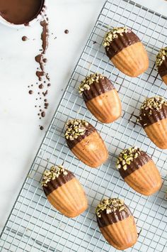 there are many cupcakes that have been placed on a cooling rack with chocolate frosting