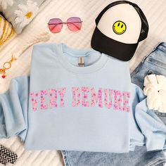 Introducing our "Very Demure" funny TikTok meme sweatshirt, designed to add humour to your wardrobe! This cosy sweatshirt is printed on demand using high-quality materials, ensuring a soft and breathable fit for ultimate comfort. Crafted with care, the pretty preppy pink floral collegiate font stands out, making it a fun statement piece for any casual outing or cosy night in. Available in sizes Small to 3XL, it's perfect for everyone who loves to showcase their unique sense of style. This sweats Spring Letter Print Fun Sweatshirt, Spring Fun Letter Print Sweatshirt, Trendy Crew Neck Sweatshirt With Funny Text, Trendy Pink Sweatshirt With Funny Print, Sweating Meme, Tiktok Design, Collegiate Font, Sage Design, Pretty Preppy